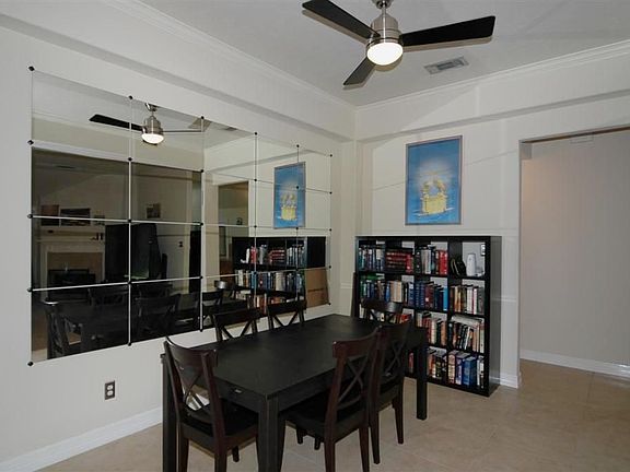  FORMAL DINING  WITH CROWN MOLDING, UPGRADED FAN, NICHED WALLS PERFECT FOR DISPLAYING ART WORK, AND ALL OPEN TO LIVING AREA! GREAT FOR PARTIES!