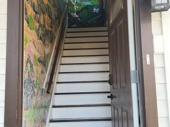 Stairway going up with mural.