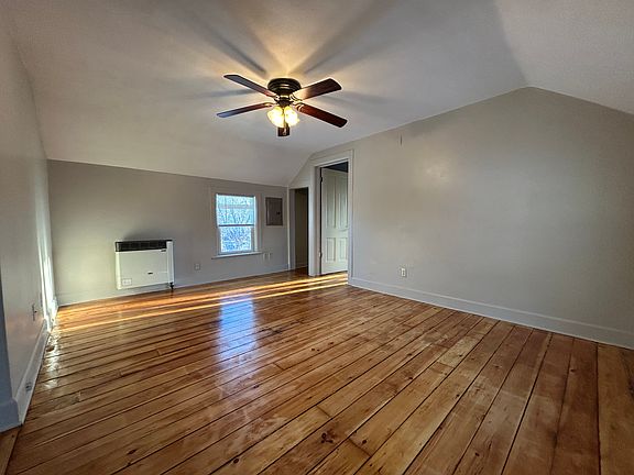 Living room with celing fan and mulitple windows for natural light