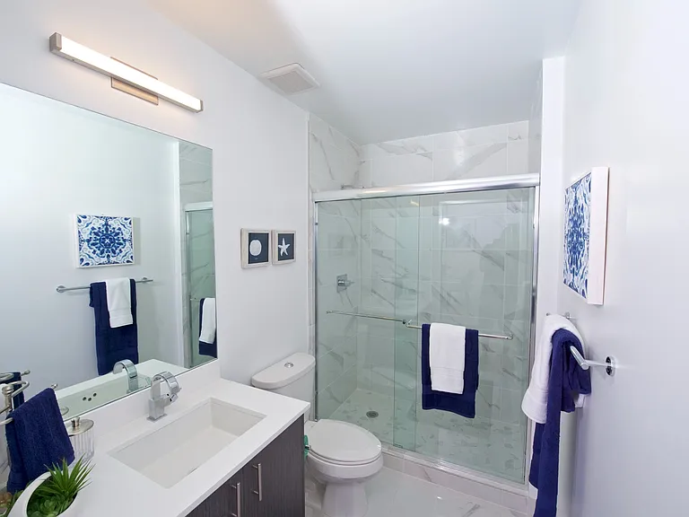 1 Bedroom Model Unit | Bathroom with Glass Shower Enclosures