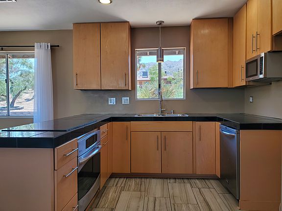 Electric cooktop, oven, dishwasher, microwave and garbage disposal included.