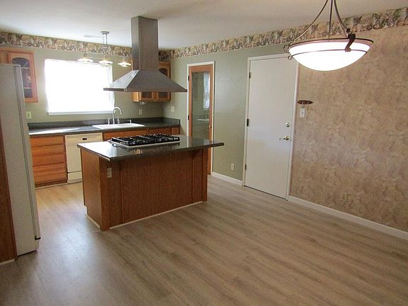Kitchen and Dining Area Featuring a Cook's Island and a Full Pantry