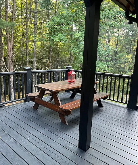 upper back deck has a picnic table..great place for outdoor eating. This area is accessible from kitchen area inside cabin through back cabin door.