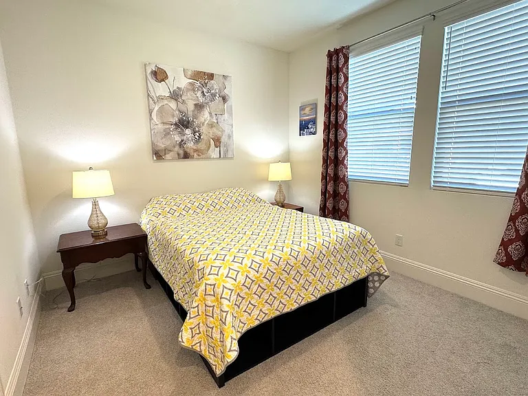 furnished bedroom has a form matress full size bed.
