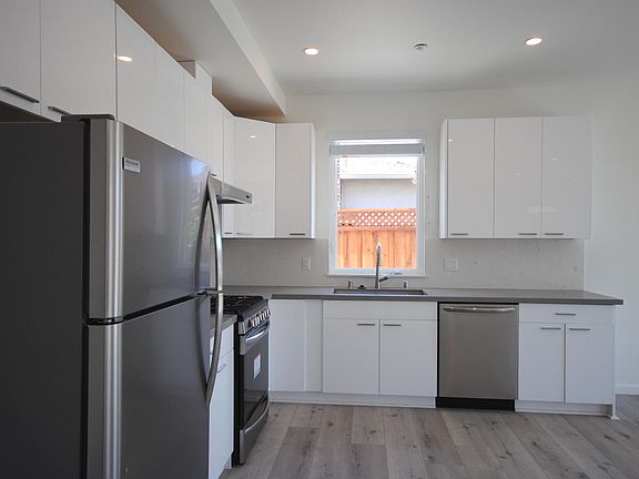 L-Shaped Kitchen with window facing sink area.