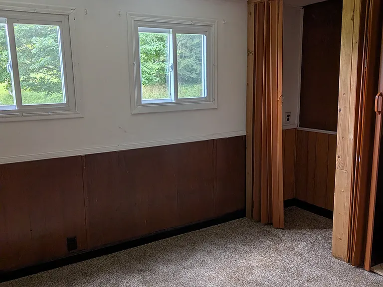 2 nd bedroom, double windows, closet. Tan carpet.
