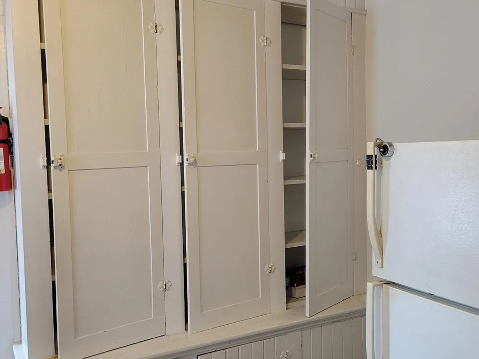 Large built in cabinet in kitchen offers plenty of pantry storage