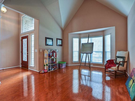 View of the Formal Living Room Boasting Lovely Paint Colors, Unique High Ceiling and Bay Window!