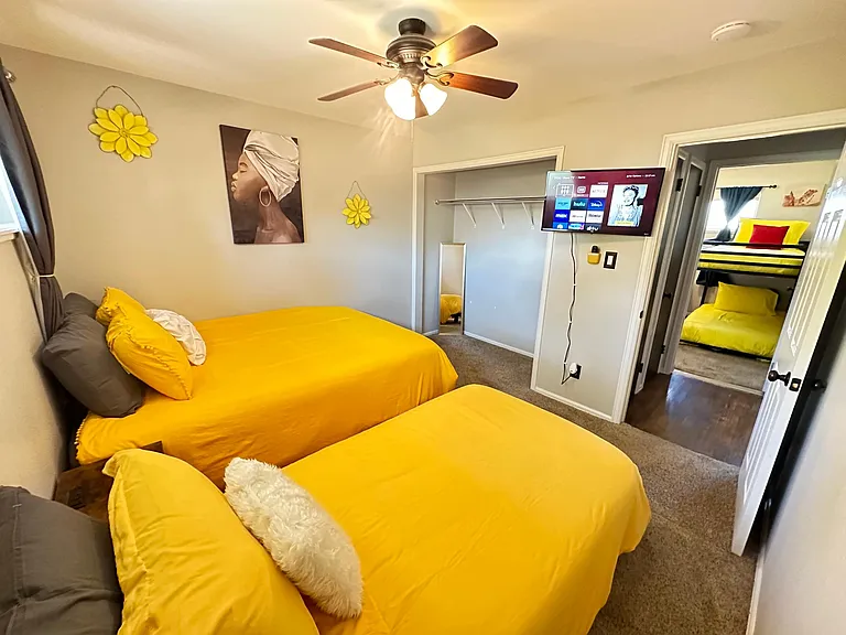 Double the Comfort, Double the Fun _ Our bedroom boasts two single beds, a smart TV, and a spacious closet for a delightful stay.