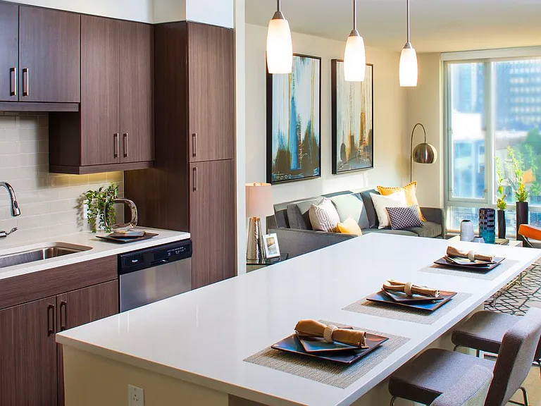 Classic Package I kitchen with espresso cabinetry, white quartz countertops, beige tile backsplash, stainless steel appliances, and hard surface flooring