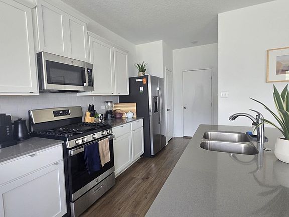 Modern kitchen outfitted with top-notch appliances and sleek countertops, ready for culinary adventures and effortless hosting.