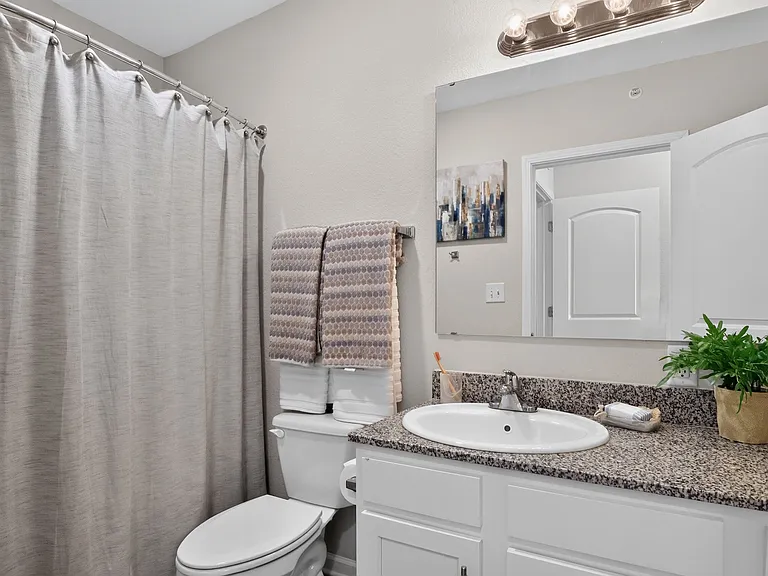 Modern Bathroom with Granite Vanity at Ralston Apartments in Downtown Indianapolis