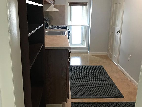 Galley kitchen is to your left, bathroom is through the door beyond on the right