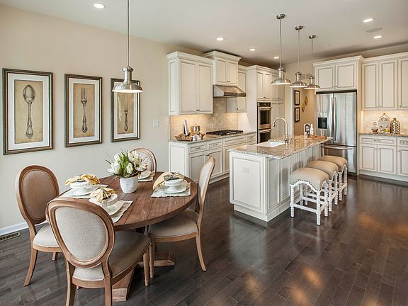Large center island in kitchen overlooks casual dining area