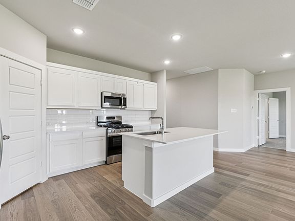 Kitchen in the Harper home plan by Trophy Signature Homes - REPRESENTATIVE PHOTO