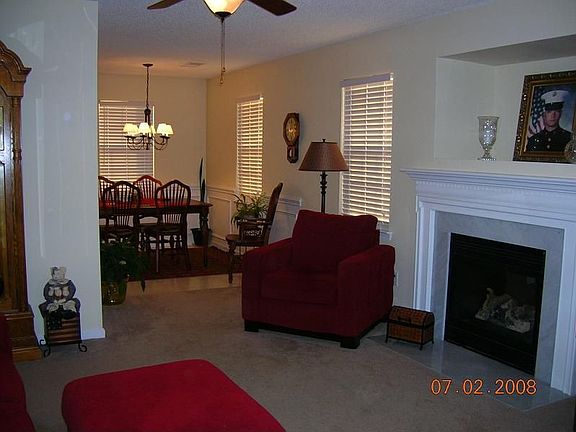 cozy fireplace in living room opens to dining