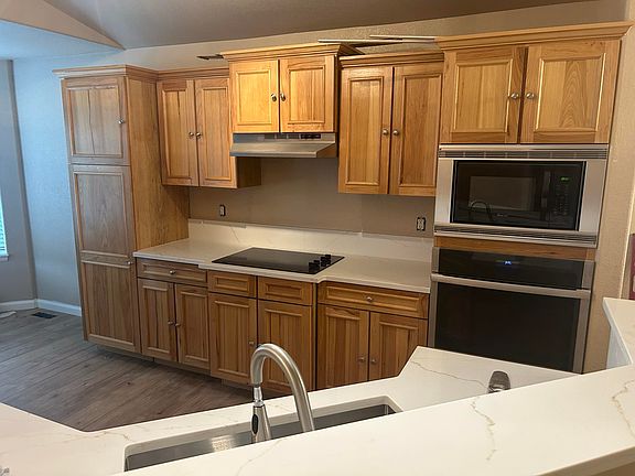 spacious kitchen with lots of cabinets and countertops