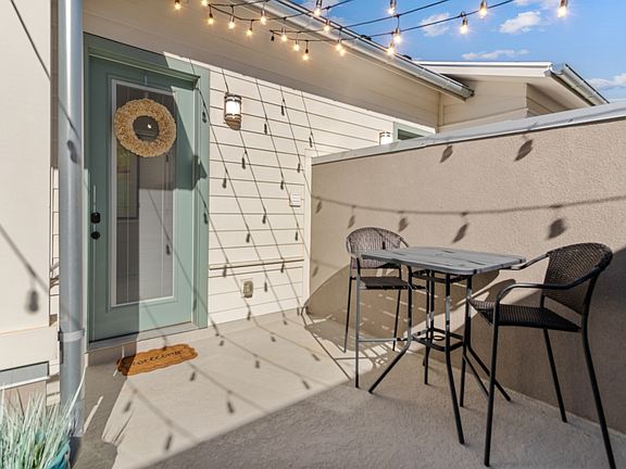 Front door entrance with partial shared deck
