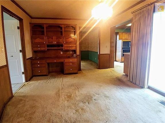 Built in desk would make a good computer room/office. However it could also be used as an eatin area to your kitchen.  Door waking out to deck.