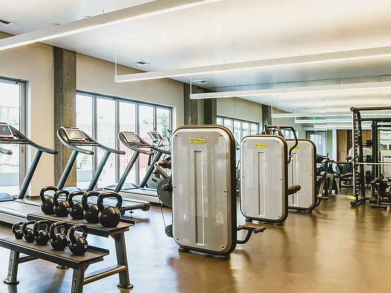 Expansive fitness center with Technogym_ strength and cardio equipment