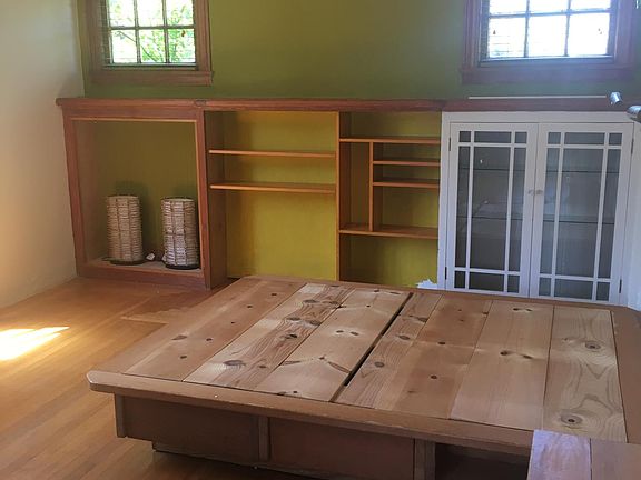 Large Master Suite features queen platform bed, built in shelving with north privacy windows and large opening windows to the west.