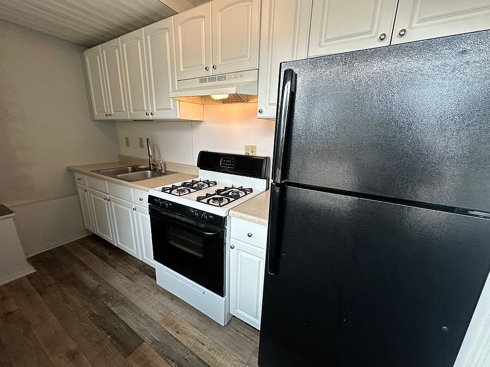 Kitchen with gas range and fridge