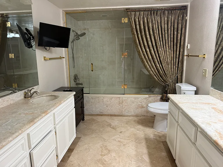 Primary bedroom bathroom with roman tub, double sinks and extra counter space