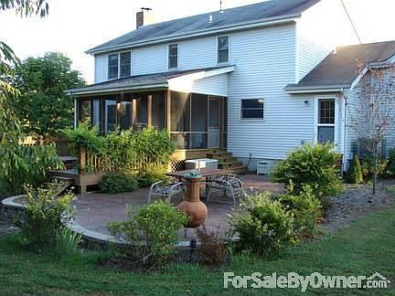 Stamped concrete patio and screened porch in back
