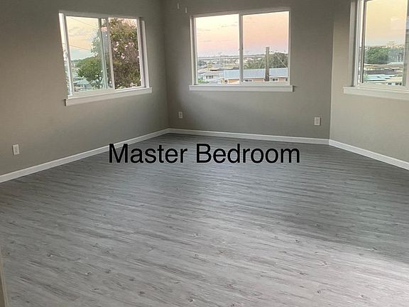Big open space Master Bedroom, Windows all around with a beautiful view, and ceiling fan