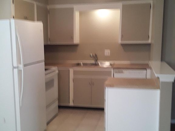 Kitchen with microwave, dishwasher, disposal and glass top range