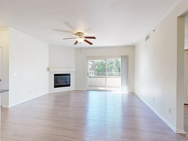 Apartment living room with wood-style flooring and patio or balcony.