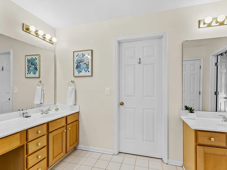 Master Bathroom equipped with dual vanities, shower, soaking tub and large walk-in closet