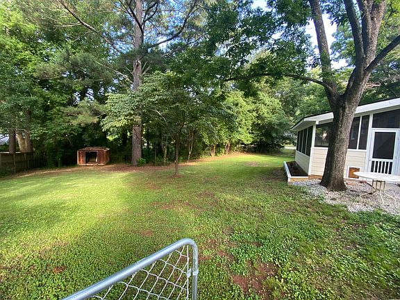View of fenced-in back yard. The screened-in porch can be seen at right.
