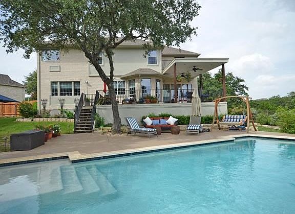 The back yard is complete with incredible views, shady trees and a refreshing pool.