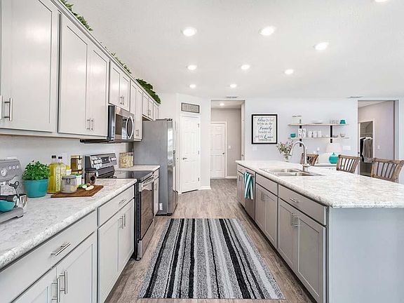 Open kitchen with counter-height island - Westbrooke home plan by Highland Homes