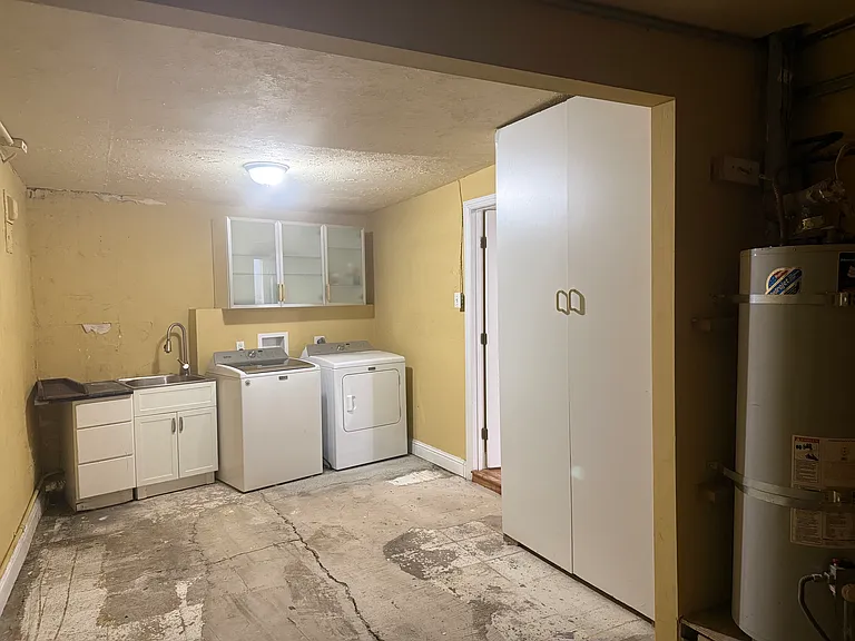 Garage with sink, washer, dryer, and large closet