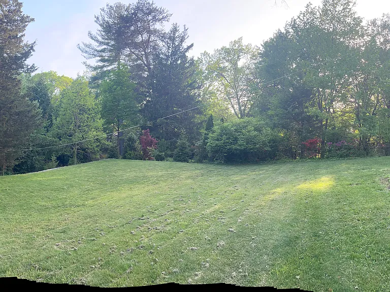 Panoramic view of part of the front yard and around to the side yard.