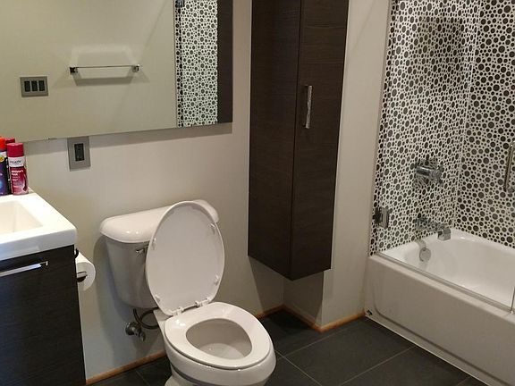 First bedrooms bathroom. All tile and a chrome waterfall sho