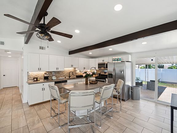 The kitchen and kitchenette are equipped with essential cooking tools, including a gas stove, coffee machine, microwave, fridge, and dishwasher.