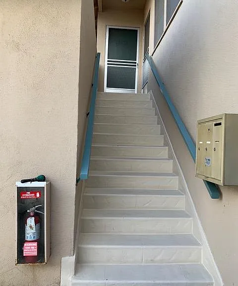 Stairs to apartment. Mail box.