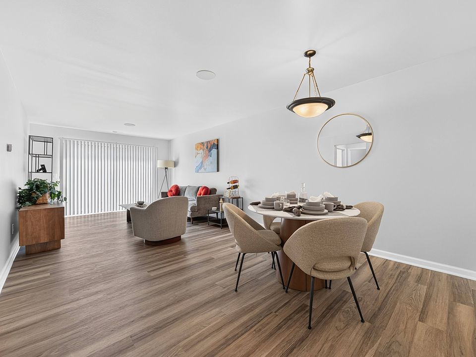 Open concept Living-Dining Area with natural lighting at Lakeside Village Apartments Clinton Township, MI