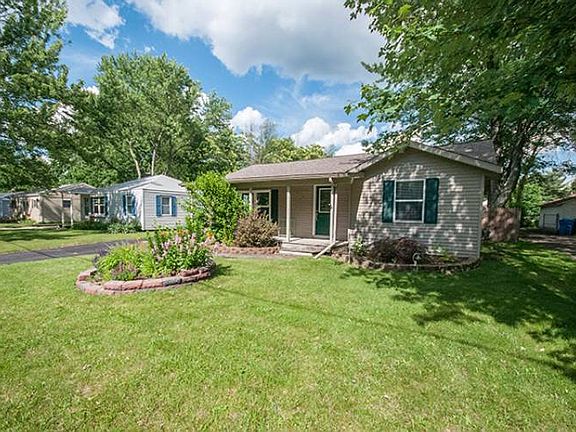 The covered front porch leads into the entry foyer connecting to the living room.