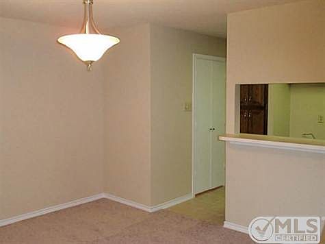 Dining room with NEW CARPET & NEW LIGHT FIXTURE. Breakfast bar