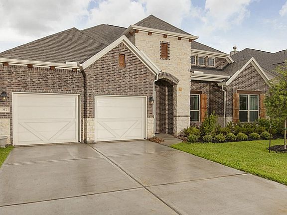This impressive stone & brick elevation masks a 3 car tandem garage!