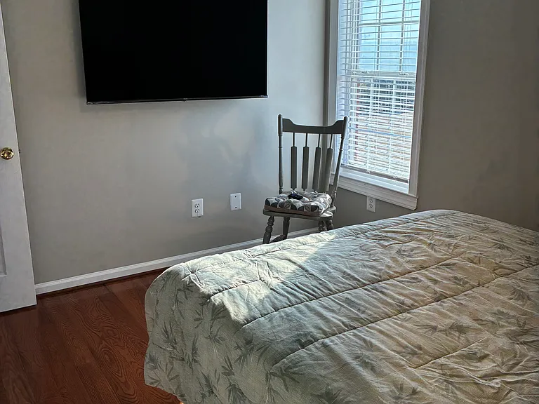 Bedroom #3 with queen size bed and wall mounted TV.