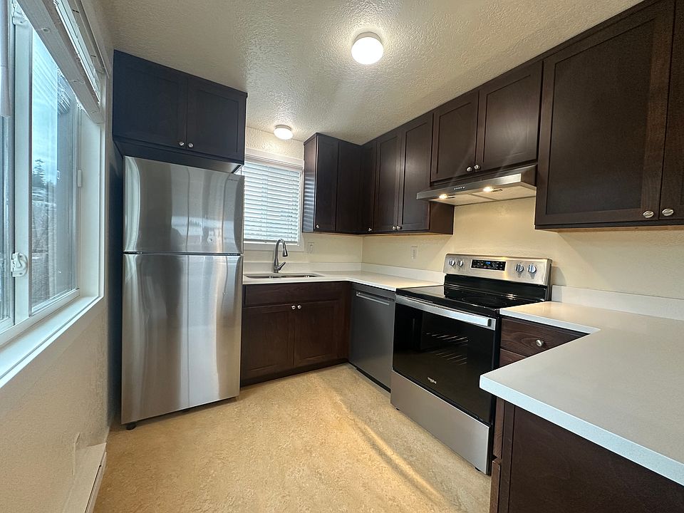 Gleaming, light-filled kitchen with full-size appliances, including dishwasher and in-sink disposal