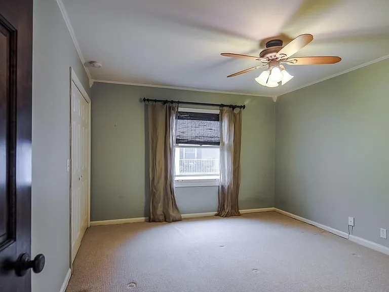 front bedroom window with large closet on left with built-in shelving