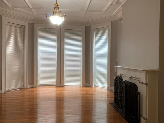 Living Room w/Decorative Fireplace and Floor to Ceiling Windows