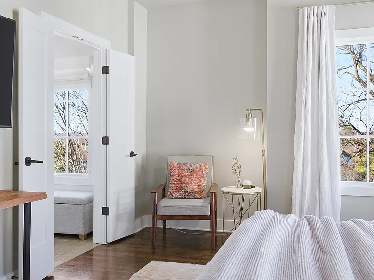 Primary bedroom on the 3rd floor with a king bed, Smart TV, ensuite bath, and room darkening shades. Includes a large walk-in closet. Tastefully decorated with high-end modern furnishings.