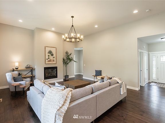 A fireplace anchors the large living room